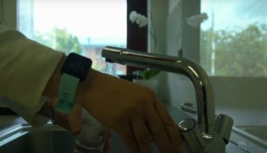 Hands filling up a glass of water from a kitchen tap